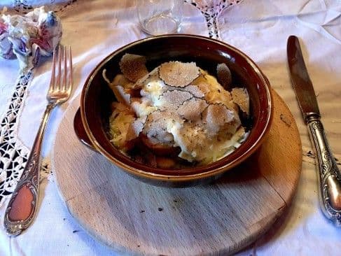 Soft poached egg garnished with freshly shaved black truffle flakes