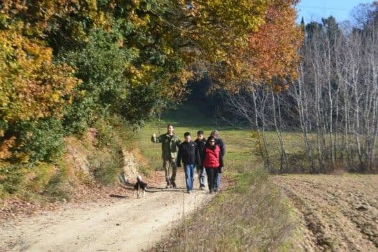 Truffle hunters and guests walking through the peaceful San Miniato forest