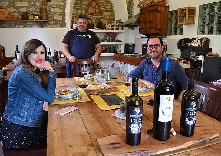 Man and woman enjoying a Tuscan lunch with wine tasting in Chianti
