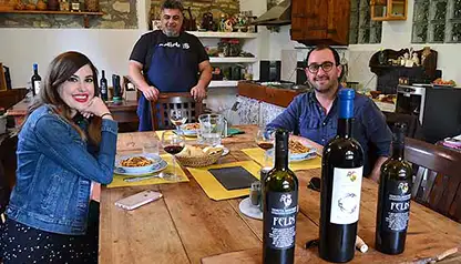 Man and woman enjoying a Tuscan lunch with wine tasting in Chianti