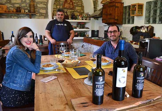 Man and woman enjoying a Tuscan lunch with wine tasting in Chianti